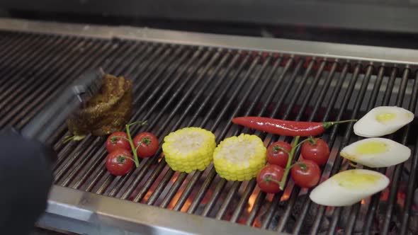 Unrecognized Chef Cooking Vegetable on the Grill in the Restaurant Kitchen alt