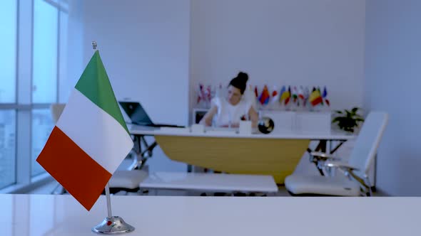 Italy Flag and Woman Working in Office