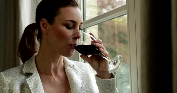 Adult Woman Stands Besides Window Drinking Glass Of Red Wine Close Up Stock Footage