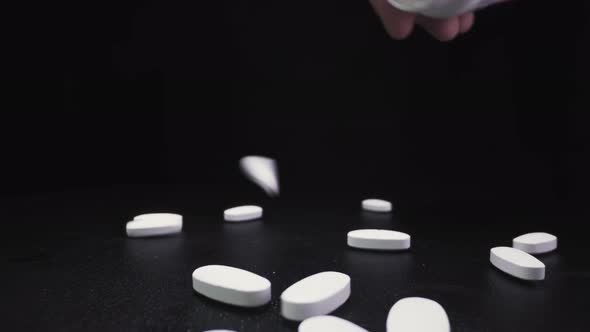 Pouring White Antiviral Drugs Onto Black Surface Close View alt