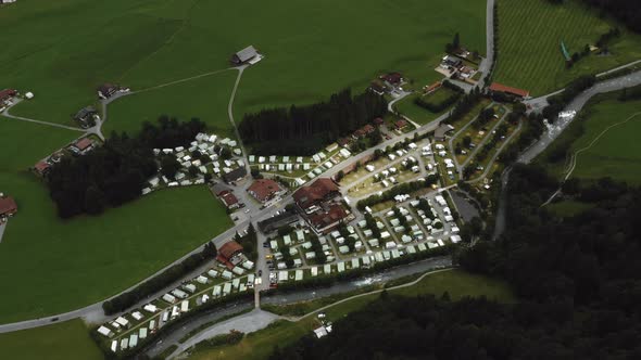 Top View Aerial Background Shot of Beautiful Little Village in Green Valley Between Mountains alt