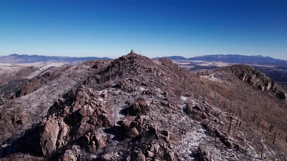 Drone shot pushing up Monjeau Peak on a sunny day in the winter alt
