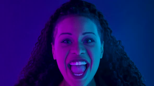 Portrait of a Young Lovely Female African American Looking at the Camera with Excitement, Then alt