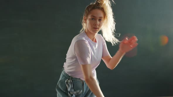 Attractive Young Blonde with Ponytail Dancing on Stage Indoors Enjoying Music alt