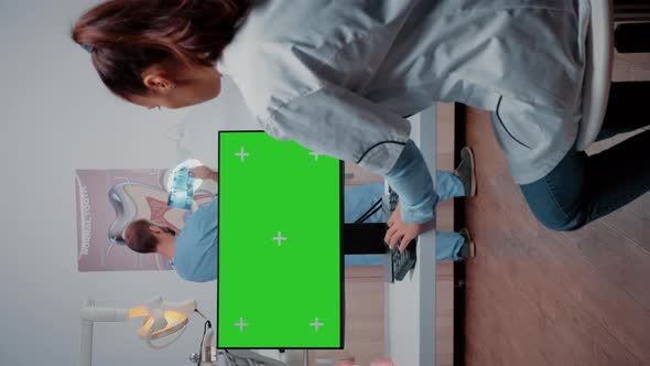 Vertical Video Specialist Using Green Screen on Monitor alt