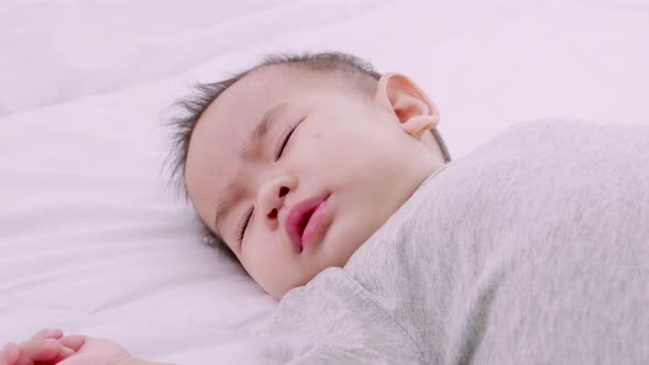 Close-up portrait of a sleeping newborn baby, Slow motion