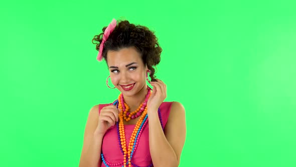 Woman Coquettishly Smiling While Looking at Camera alt