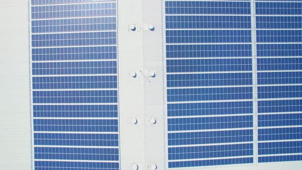 Aerial cinematic view of a solar panel on mall roof top alt
