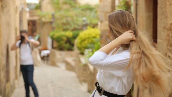 Photographer photographing young beautiful woman