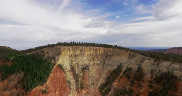 Aerial video of cliff canyon with forest on a sunny day (Zion National Park, Utah, USA) alt