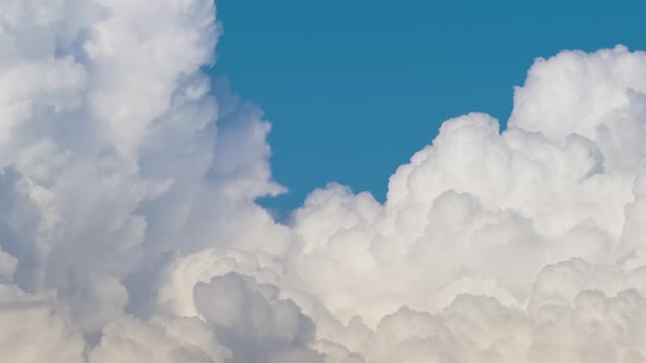 Timelapse of White Puffy Cumulus Clouds Forming on Summer Blue Sky alt