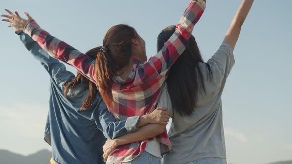 The group of young Asian women looks to view the mountain and having fun together in the summer.