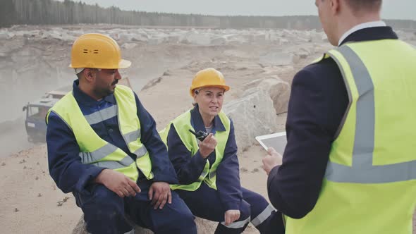Manager with Tablet Talking to Workers by Granite Quarry alt