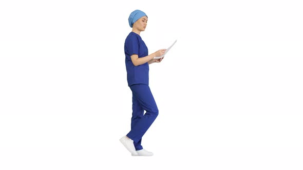Female Professional Doctor or Nurse Reading Medical Form While Walking on White Background. alt