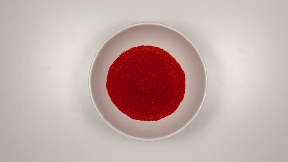 Red pepper powder fill a white dish