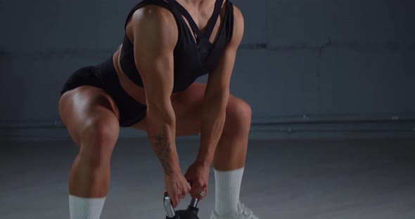 Muscular Woman Doing Exercises with Kettlebell alt