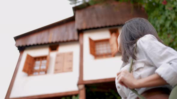 Woman Looking At Historic House On The Street alt