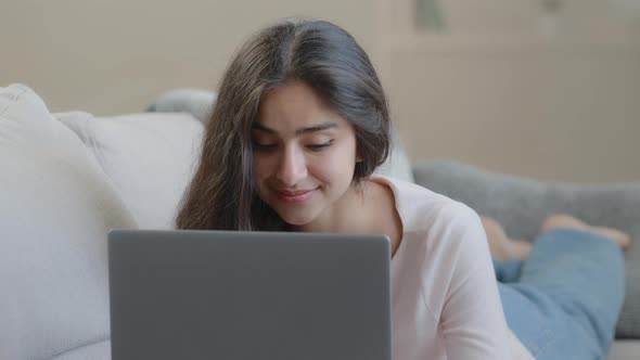 Carefree Woman Lying on Sofa Working on Laptop Searching Online Information Playing Computer Game alt