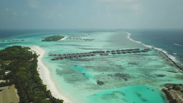 Aerial Drone View of a Beautiful Atoll or Island with a Resort in the Maldives alt
