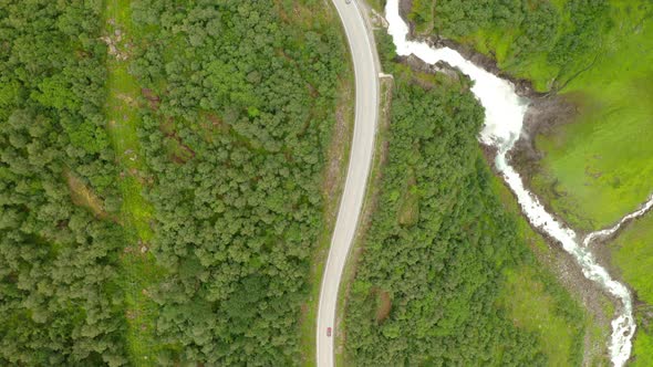 Aerial View Of Vehicles Driving On Road At Forest Valley To Stryn In Norway. - Tracking Shot alt