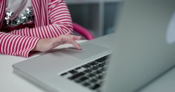 Close up Hands of Unrecognizable Child of Primary School Age Using Touchpad of Laptop Computer