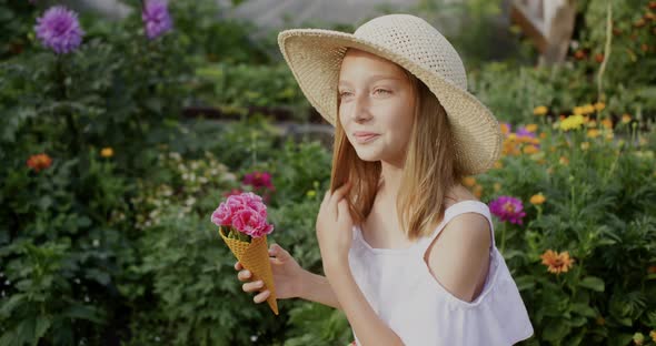 Smiling Teen Girl Holding Waffle Cone with Flowers in Garden alt