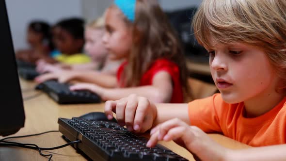 Little Boy Smiling at Camera During Computer Class alt