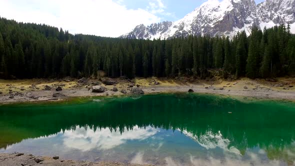 Stunning turquoise lake Carezza in the Alps at sunrise in spring, Italy alt