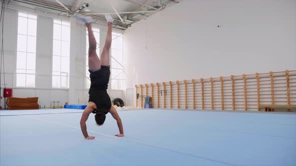 A Sportsman is Doing a Cartwheel and a Double Back Flip and Lands Steadicam alt