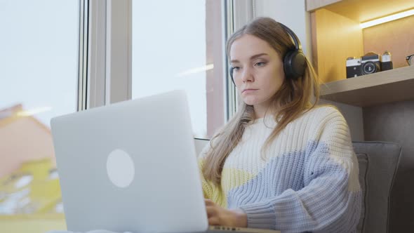 Remote study, work. Studying on a laptop at home. Work at home. A woman works remotely from home. alt