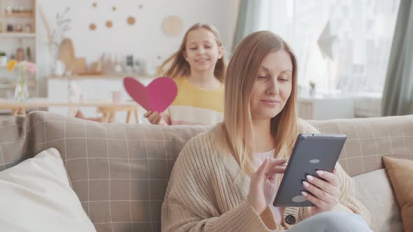 Daughter Giving Handmade Postcard to Her Mum alt