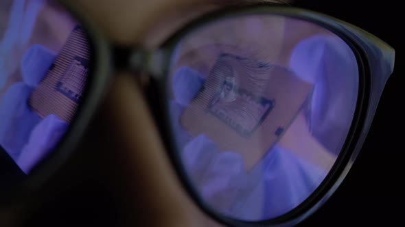 Female Scientist in the Glasses Looking the Presentation of the New Microchip
