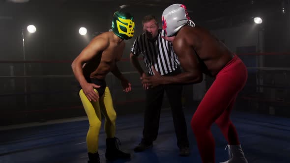 Masked wrestlers prepare to fight alt