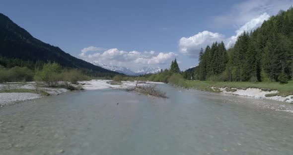 Flight along riverbed in the mountains, Bavaria, Germany alt