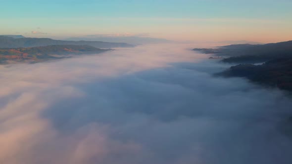 4K Sun is rising above sea of clouds until the horizon alt