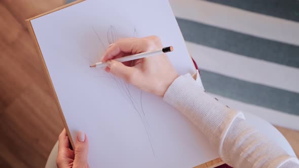 Woman Artist Sketching on White Paper.