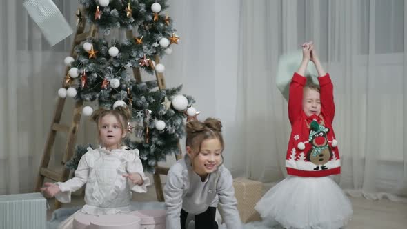 Happy American family celebrating Christmas. Children open a gift at home. alt