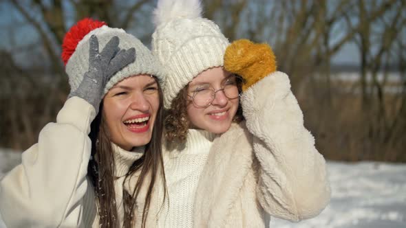 Young Woman and Her Teenage Daughter are Having Fun on a Winter Walk alt
