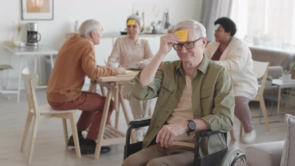 Senior Handicapped Man with Sticky Note alt