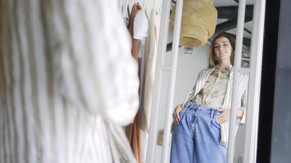 Elegant Young Woman in Denim Jeans and Striped Jacket