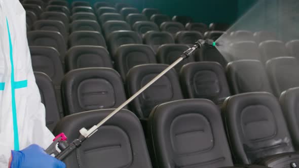 Worker Disinfect Cinema Hall Against Coronavirus alt