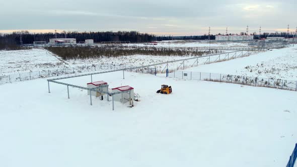 A Drone Flies Over an Industrial Facility Located in an Oil Field in the Winter alt