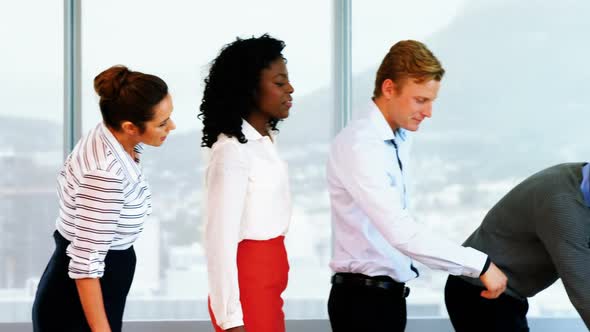 Executives waiting in a queue to drink water alt