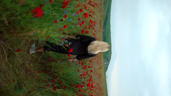 Young Blondie Girl in Poppy Field Walking Spring Time Red Flowers Vertical Video