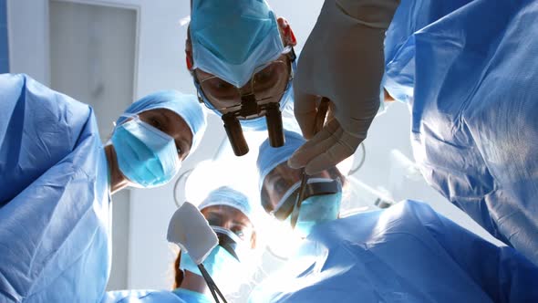 Surgeons performing operation in operation room alt