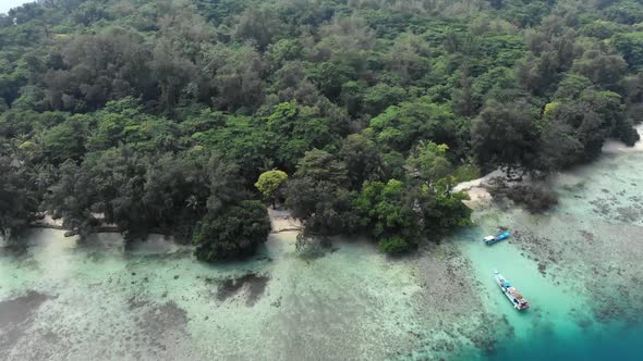 Aerial view of a beautiful island in the ocean with a boat