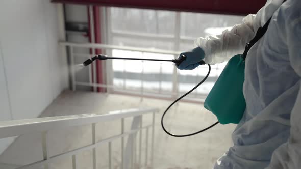 Sanitizing of Railing in Public Place During Pandemic of Coronavirus alt