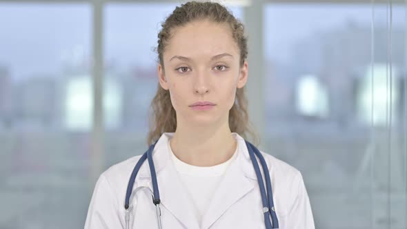 Portrait of Young Female Doctor Looking at the Camera  alt