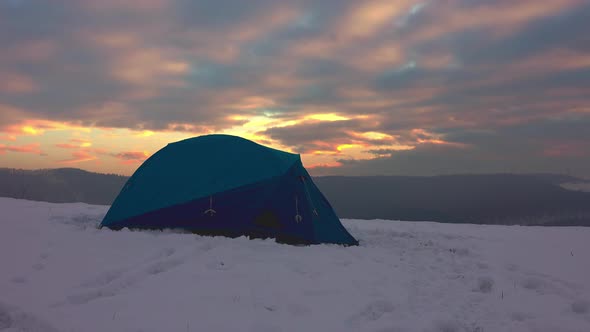 Hiker in shorts getting out from tent, enjoying cold weather alt
