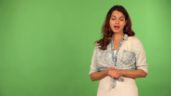 A Young Beautiful Caucasian Woman Talks to the Camera  Green Screen Background